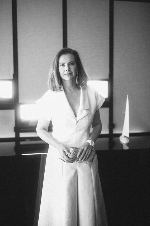 <strong>Carole Bouquet</strong>, French actress and Muse of the new J12 watch, wore a white fantasy tweed jumpsuit from the Spring-Summer 2019 Ready-to-Wear collection, CHANEL bag, shoes and makeup paired with CHANEL’s "Cascade de perles" earrings in 18K white gold, pearls and diamonds and “J12” watch in white ceramic.