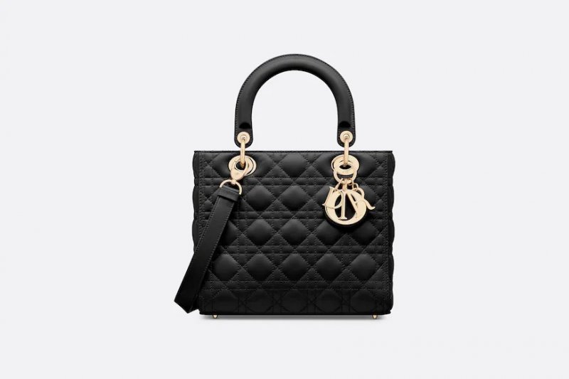 <strong>The Lady Dior by Dior</strong><br />
Some might know its story but let’s refresh your memory a little bit. On a visit made by Princess Diana to Paris, Bernadette Chirac – the wife of then French president Jacques Chirac – commissioned the House of Dior to design a bag fit for a princess, and the result was just perfect. Made of black quilted leather, the bag wasn’t slouchy just like a princess’s posture, and featured a pair of demi-arched handles and yellow gold hardware. Since Lady Diana showed her deep admiration for this bag, it became a key element in Dior’s handbag collections, presented in many variations and sizes.<br />