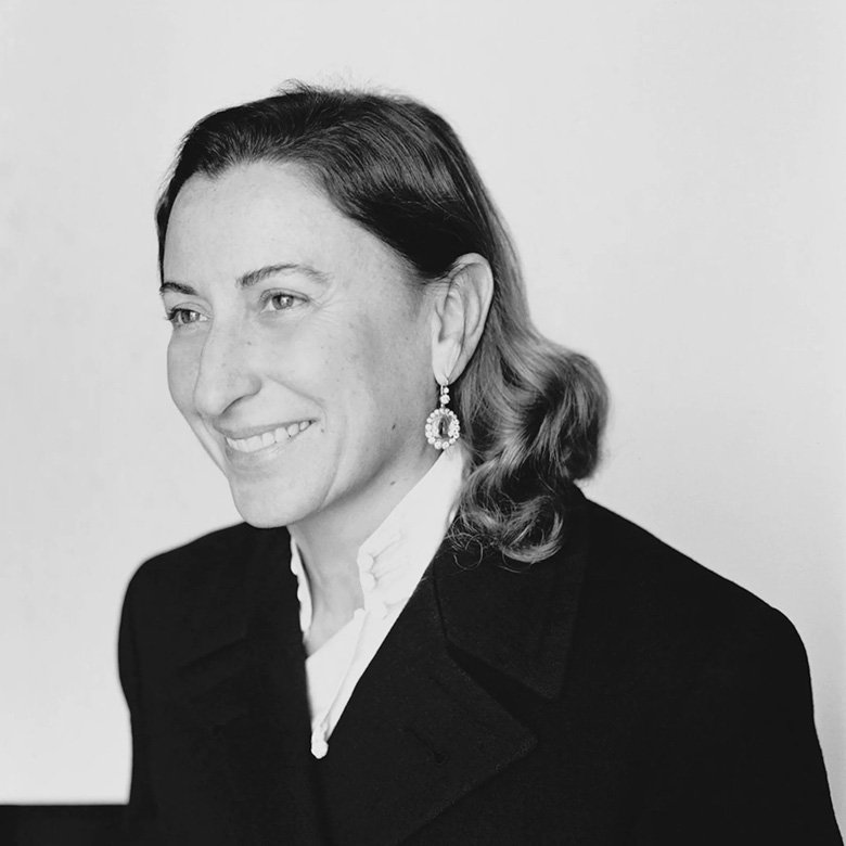 <strong>Miuccia Prada</strong><br /> <em>Photo Courtesy of Pradagroup.com</em><br />
Taking over her father’s company, she turned it into a force to be reckoned with in the world of fashion. Her vision was a mix of intellectual and complicated references, coming from her Ph.D. in political science and leading the house to success.<br />
 