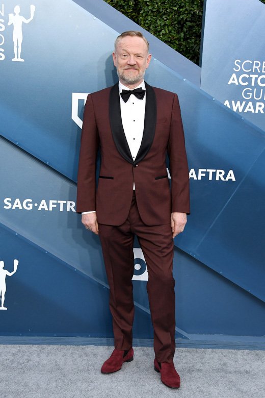 <strong>Jared Harris</strong>, wearing a rust-coloured BOSS shawl collar from the current collection.