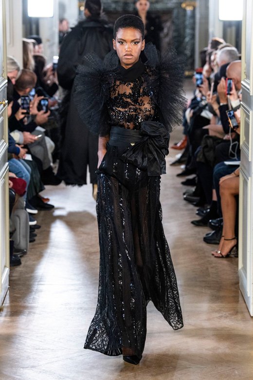 <strong>آنّا إيورز</strong>&nbsp;لامعة ببدلة توكسيدو من عرض أزياء&nbsp;<strong>ماكس مارا&nbsp;</strong>لعام 1989 مؤلّفة من سترة رسميّة صوفيّة قصيرة ذات تفاصيل حريريّة وسروال صوفيّ. &nbsp;